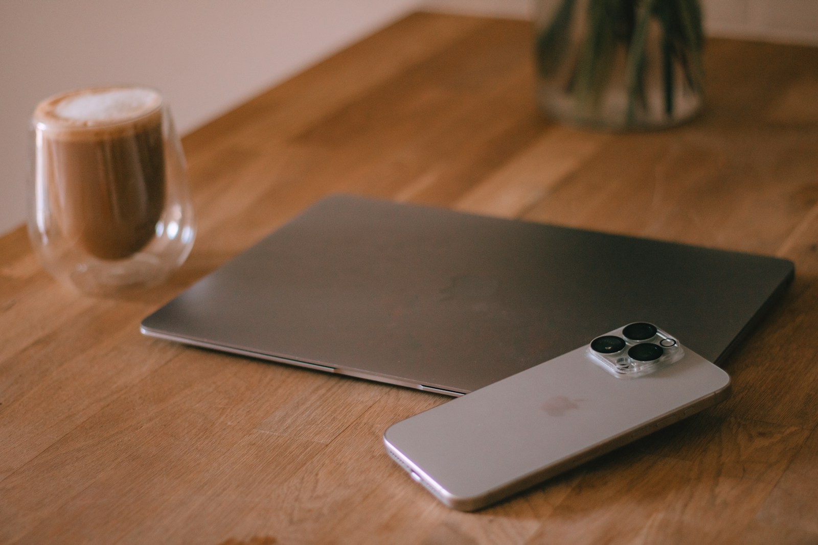 A laptop computer sitting on top of a wooden table