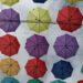 a bunch of colorful umbrellas hanging from wires