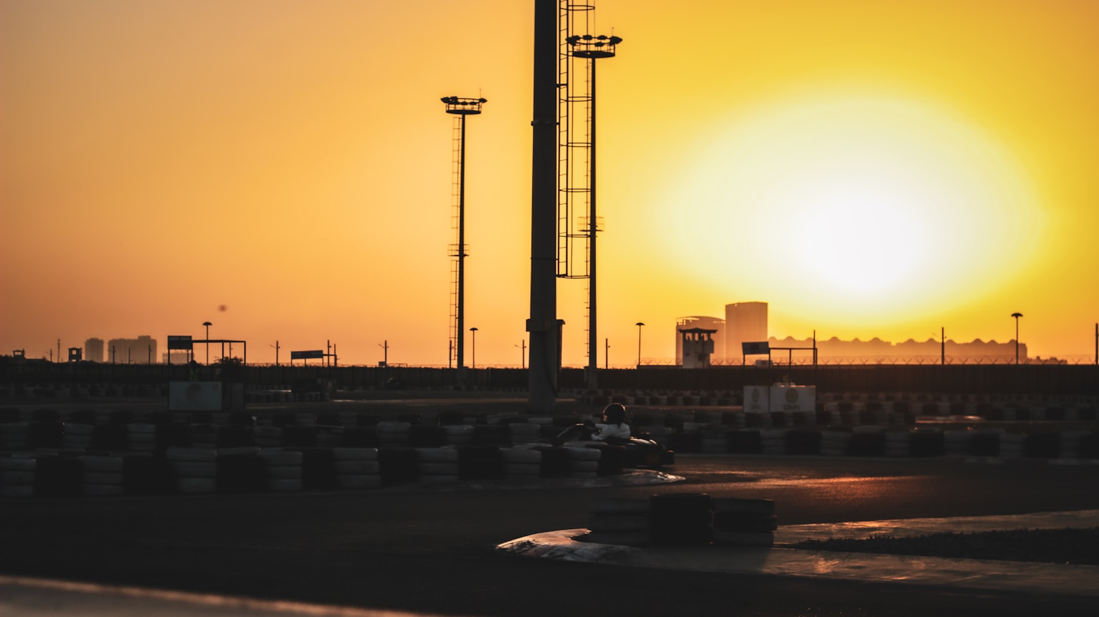 the sun is setting over a race track