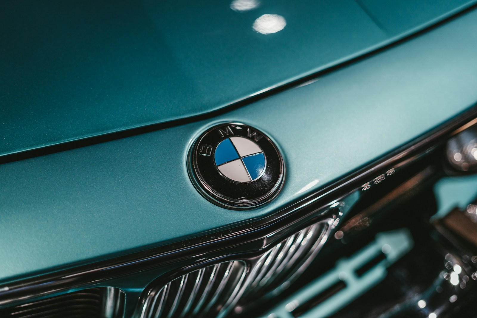 green bmw car in close up photography