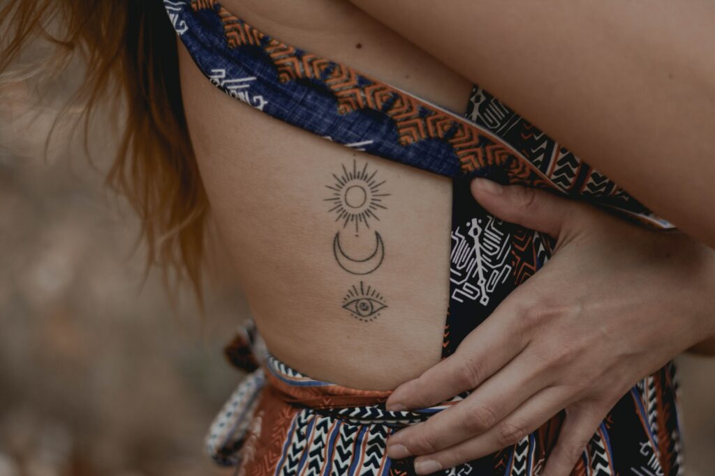 woman with floral tattoo on her right arm