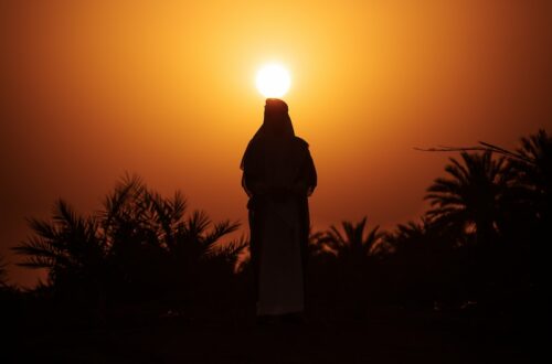 a person standing in front of the sun